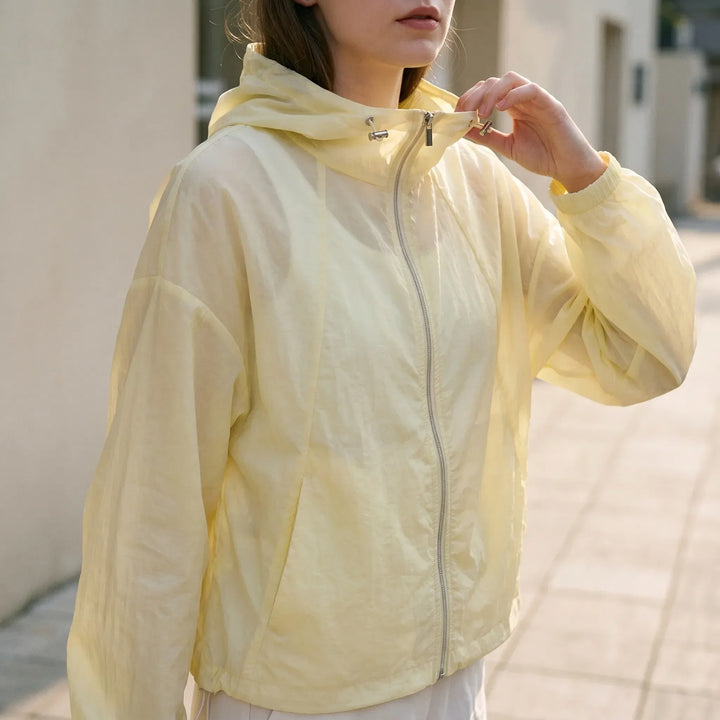 Women's lightweight hooded windbreaker jacket, full zip, perfect for spring & summer activewear.