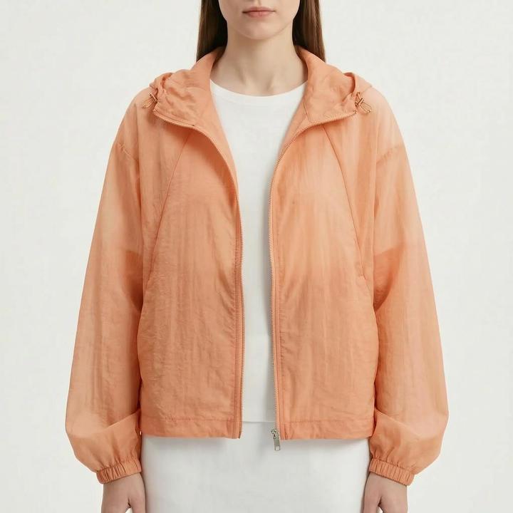 Stylish women's lightweight hooded windbreaker jacket in a vibrant color, perfect for spring outfits.