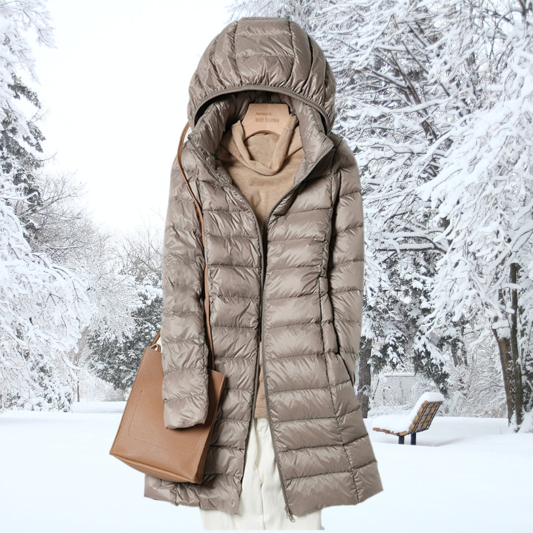 Packable women's lightweight insulated hooded travel jacket, perfect for cold weather journeys.