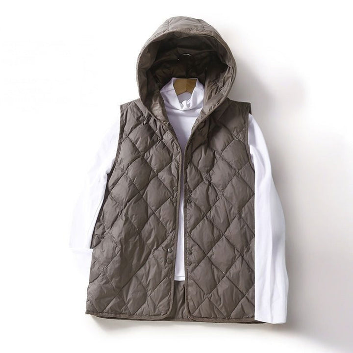 Black women's quilted vest with hood, a chic and lightweight layering essential for any casual outfit.