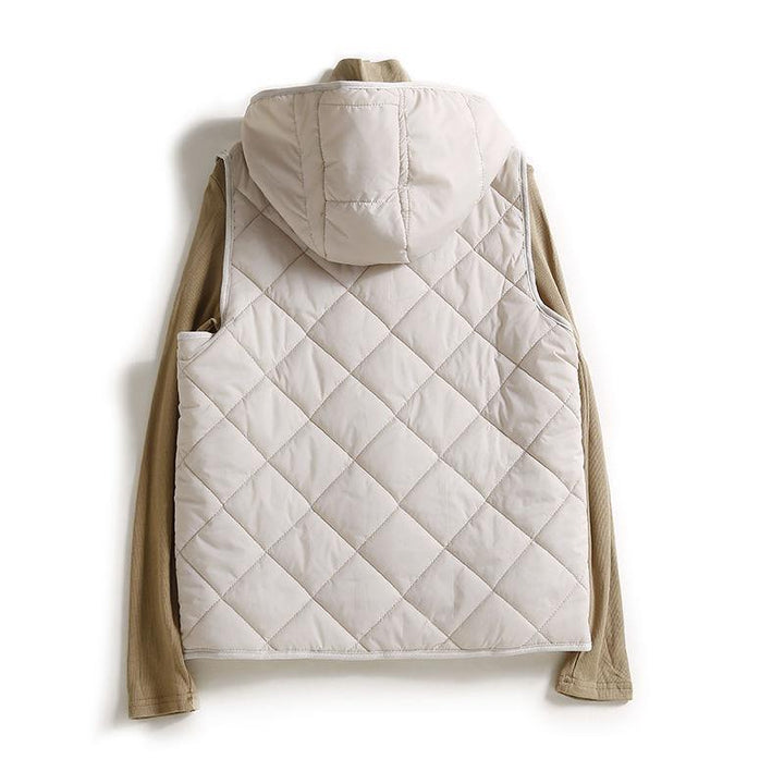 Brown women's hooded quilted vest, offering cozy warmth and modern style as a fall outerwear piece.