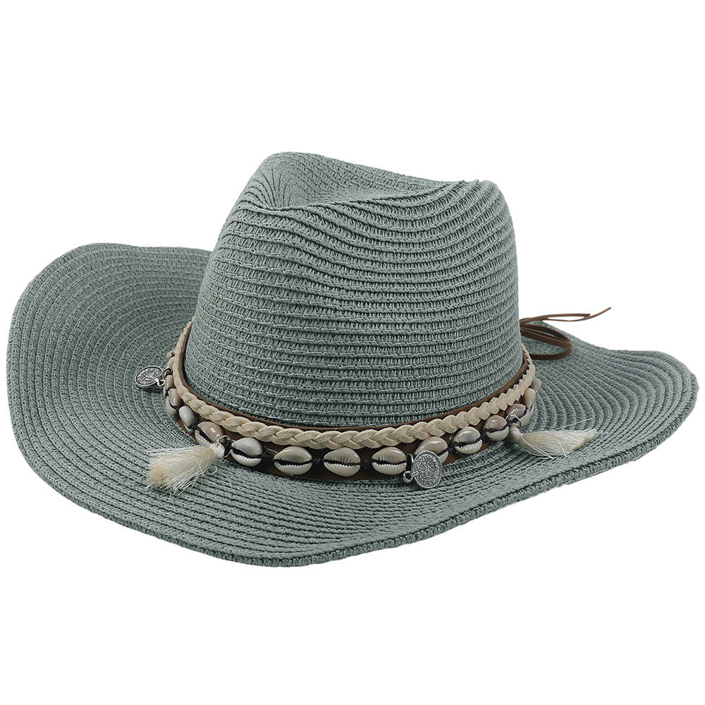 Women's lightweight straw sun hat with shell and tassel embellishments, perfect for summer beach protection.