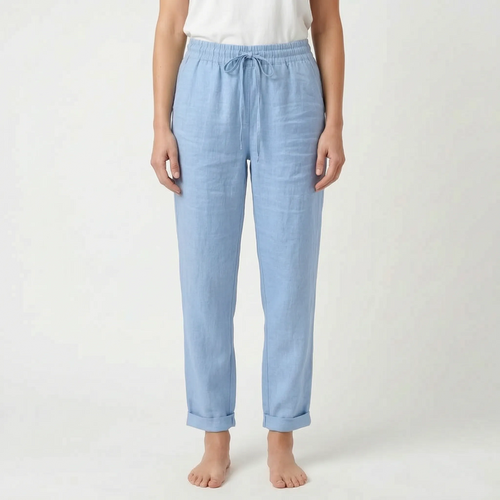 Woman wearing ankle-length tapered summer pants, relaxed fit & lightweight, ideal for a stylish casual look.