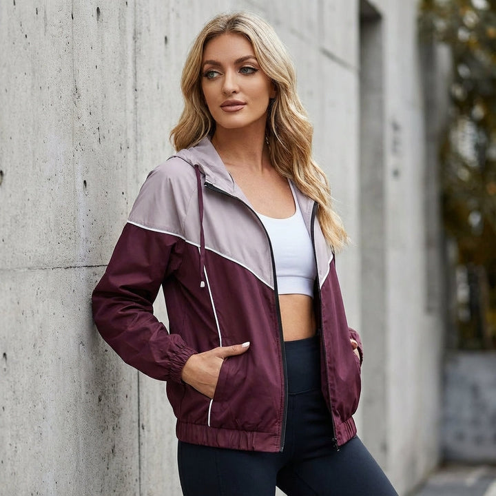 Women's lightweight water-repellent sport jacket, color block design, for athletic outerwear.
