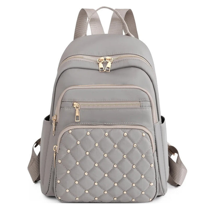 Side view of women's lightweight nylon travel backpack, showing slim profile & water-resistant material. Perfect for daily carry.
