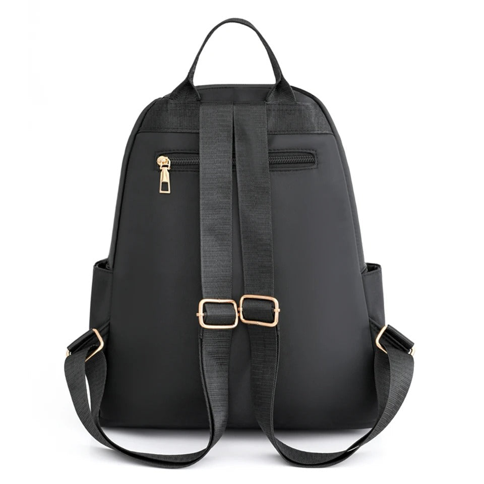 Close-up of durable water-resistant nylon fabric on women's lightweight backpack. High-quality material for daily & travel use.