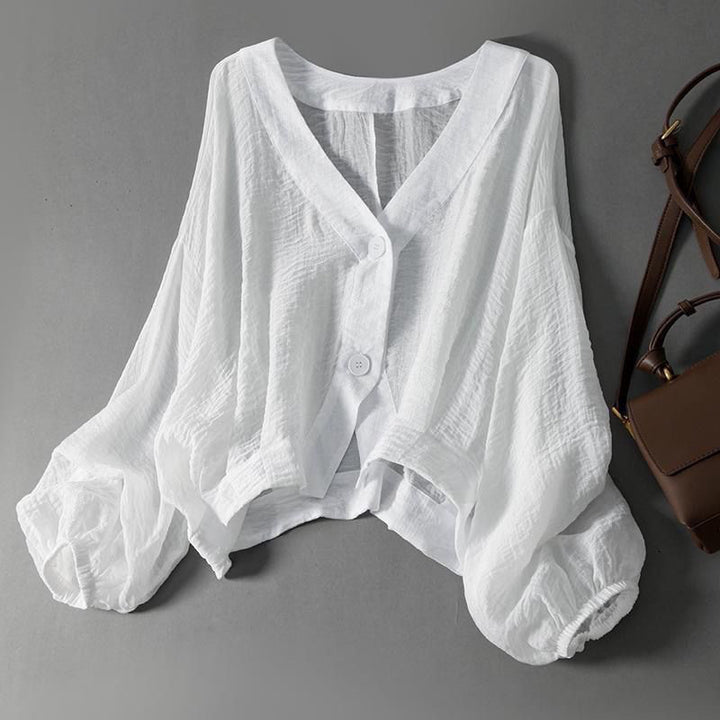 Women's lightweight white blouse with chic balloon sleeves and button front. Perfect flowy top for spring/summer style.