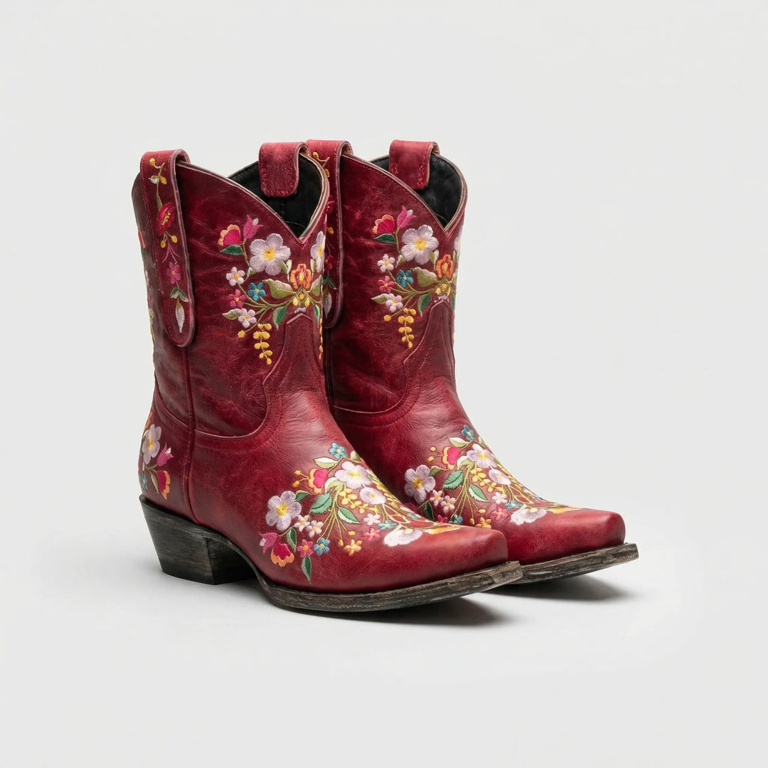 Close-up of women's western ankle boots with vibrant floral embroidery and a comfortable block heel.