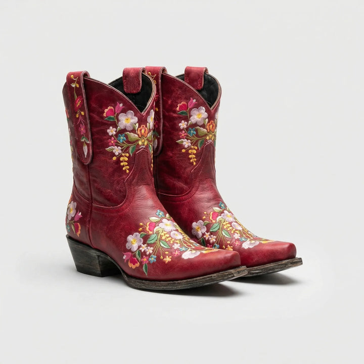 Close-up of women's western ankle boots with vibrant floral embroidery and a comfortable block heel.