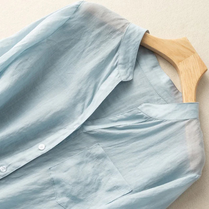 Elegant women's blue Élise blouse, a stylish top with a mandarin collar and relaxed fit, ideal for casual wear.