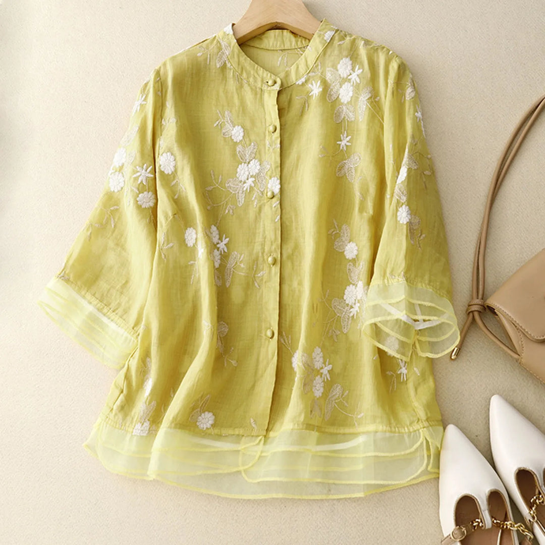 Beautiful Élodie Bloom sheer blouse, vibrant floral embroidery, available in green, white, yellow.