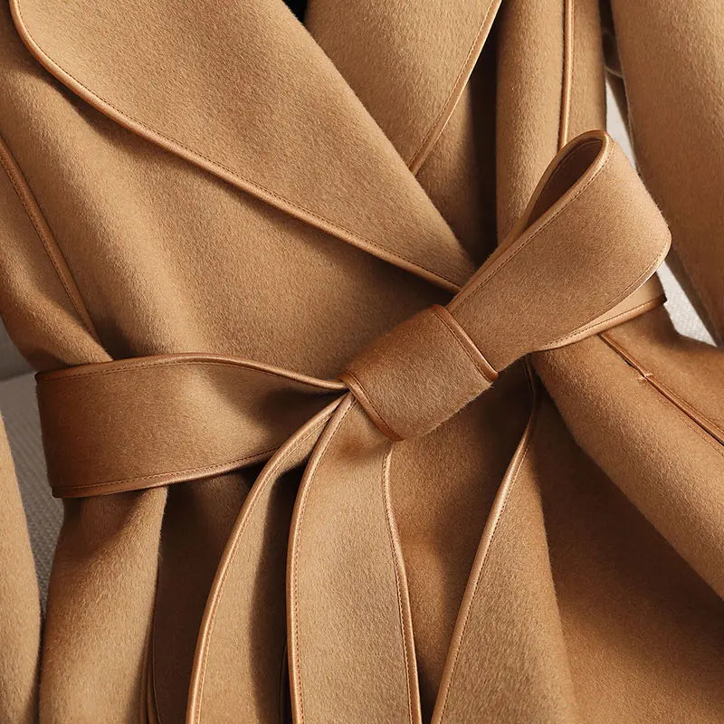 Classic women's long trench coat, belted for a tailored fit. Stylish outerwear for elegant fall & winter fashion.