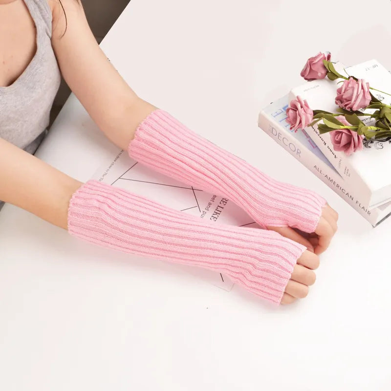 Women's long fingerless knitted gloves, providing cozy winter warmth & stylish comfort for cold days.