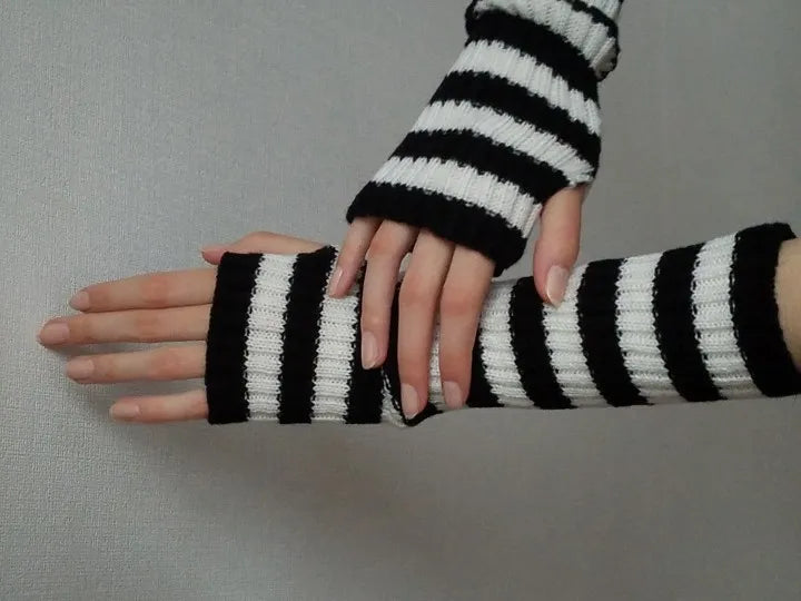 Women's long knitted arm warmers with a fingerless design, essential winter accessory for warmth & flexibility.