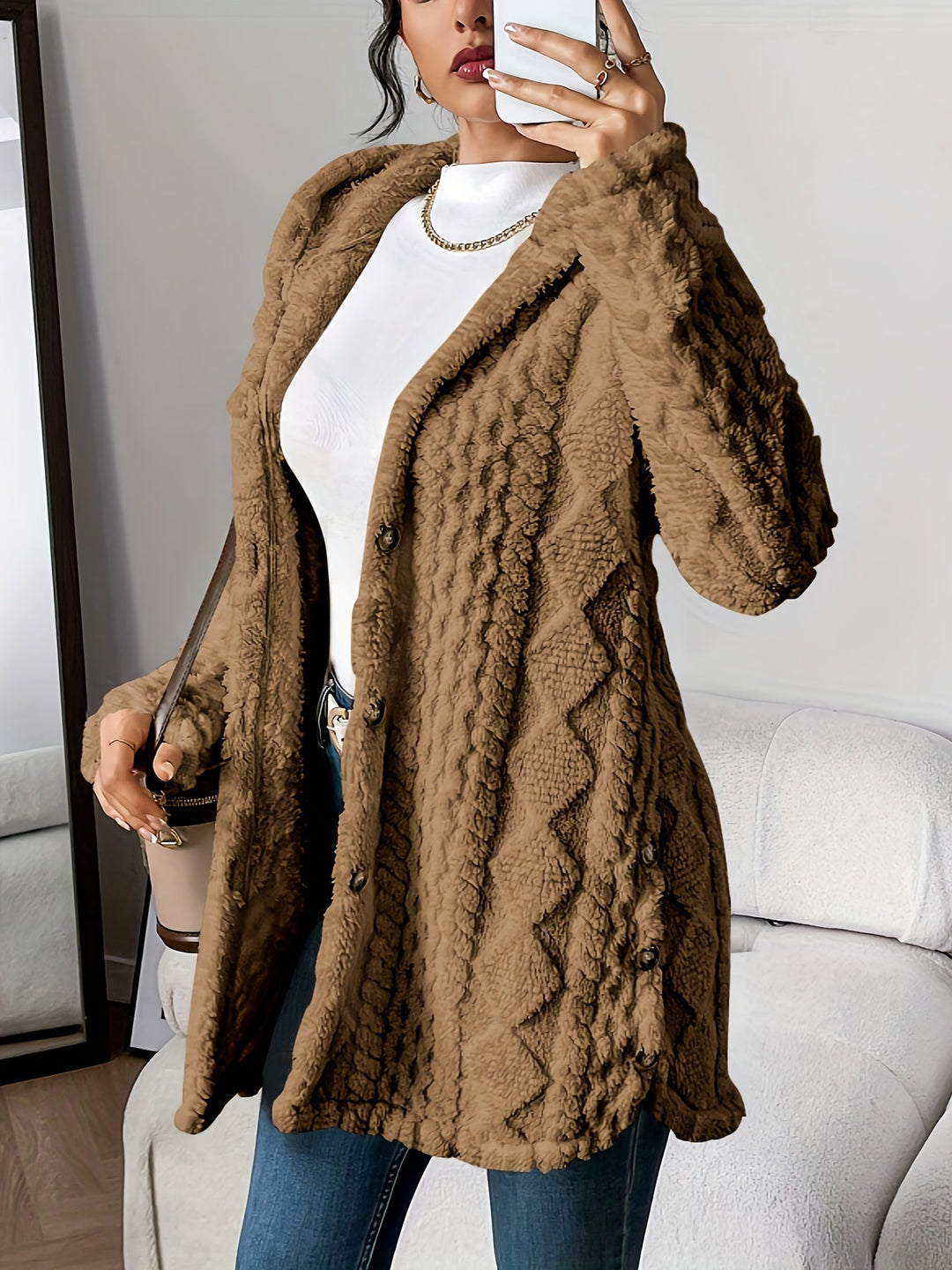 Textured women's long hooded coat with button closure, comfortable & stylish fall/winter outerwear.