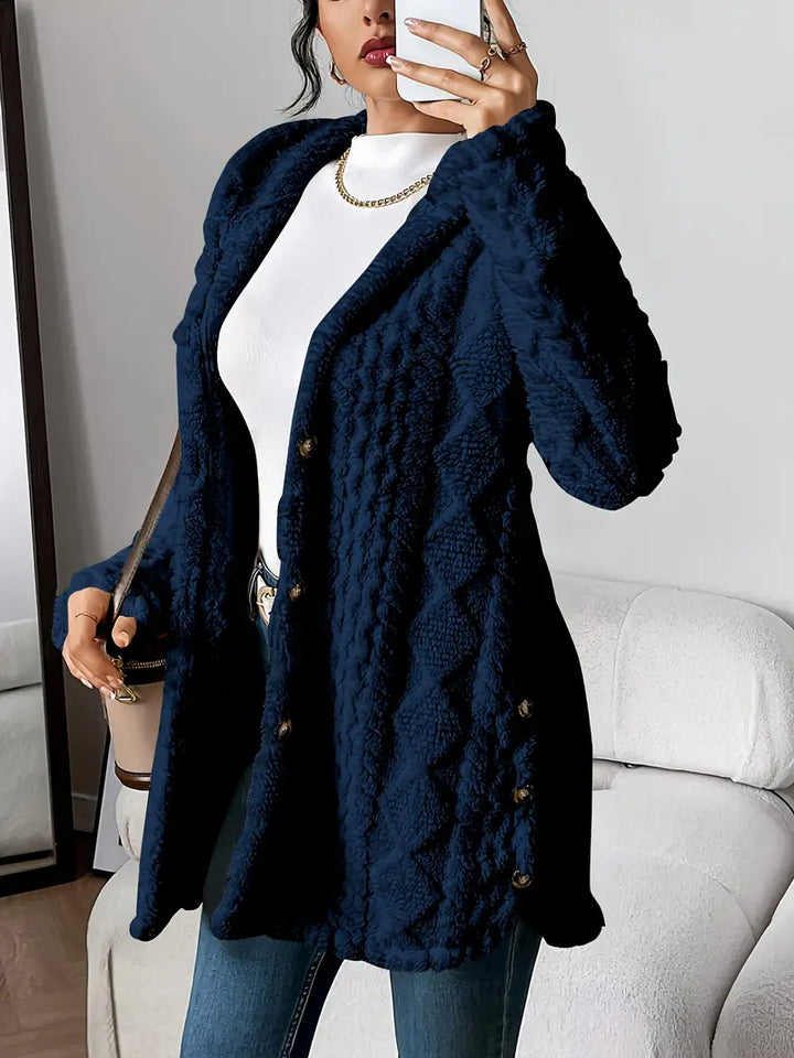 Casual yet elegant women's long textured hooded coat with button closure, warm fall/winter outerwear.