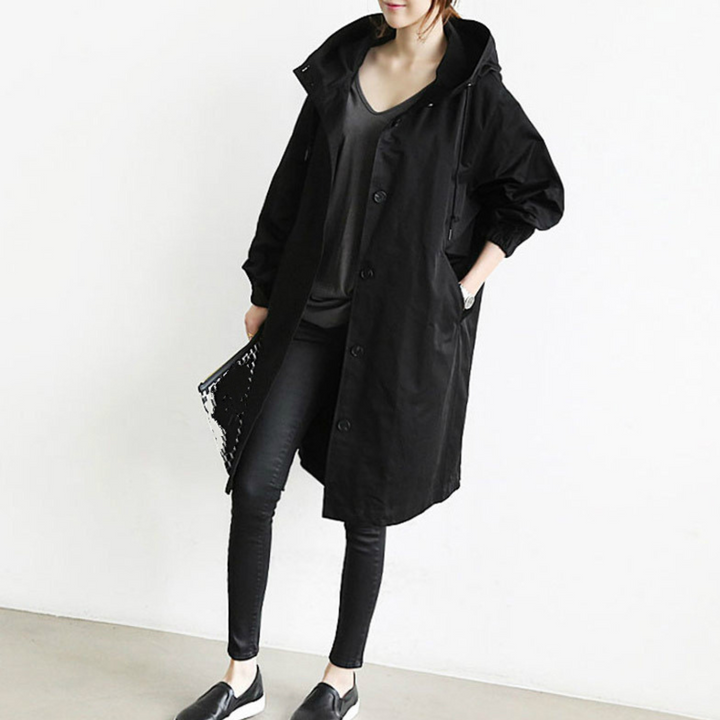 Women's long hooded trench coat for stylish rain protection and fashion outerwear.