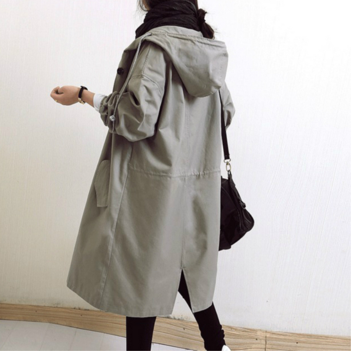 This women's long hooded trench coat offers stylish protection from spring and fall weather.
