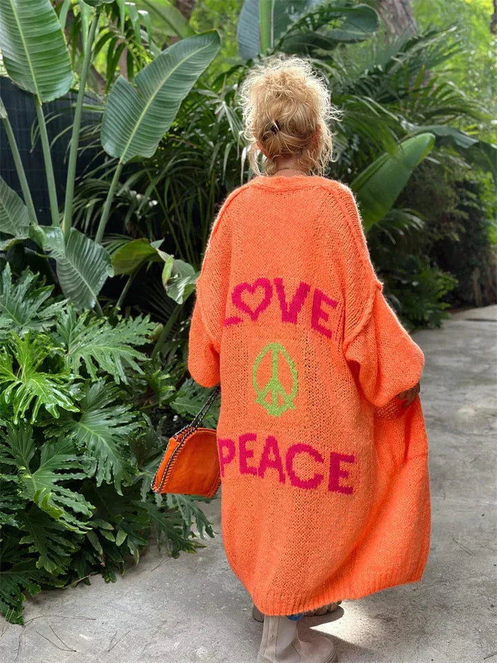 Women's long oversized knit cardigan, a vibrant bohemian statement piece with a relaxed, open front.