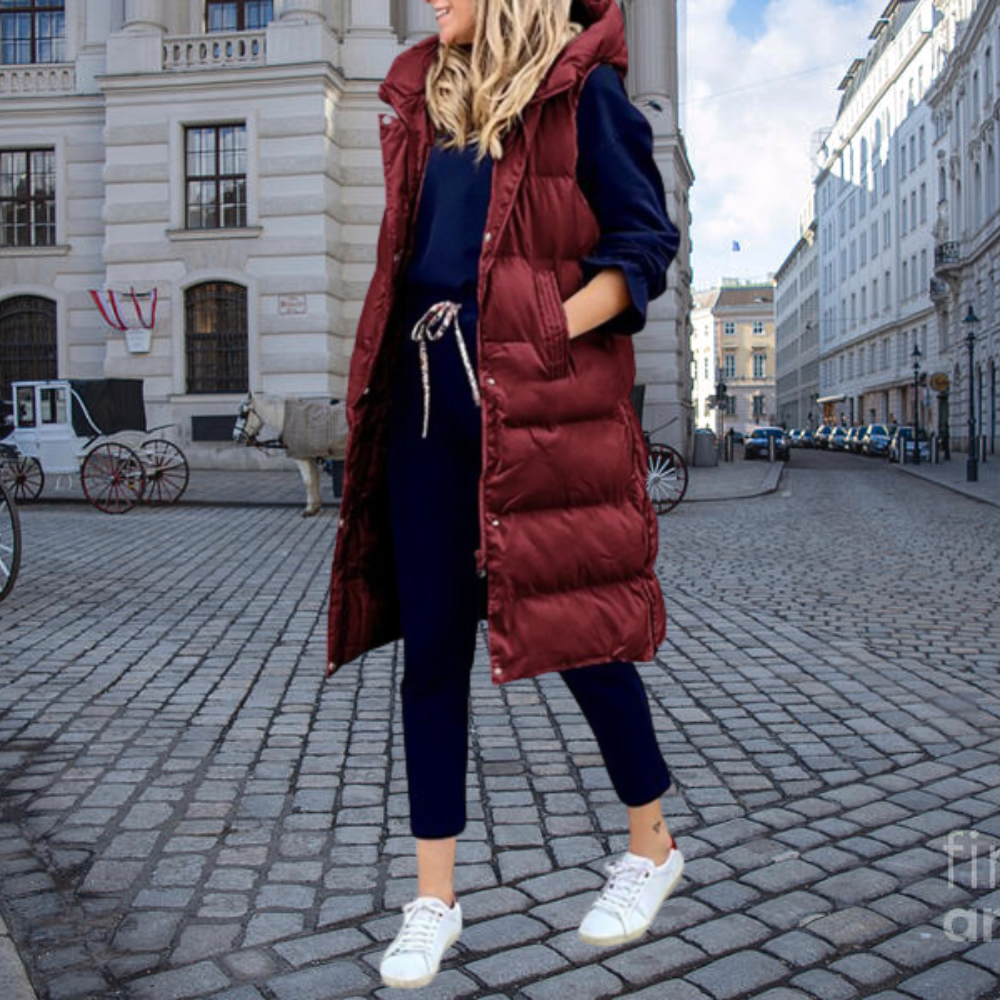 Stylish women's long padded gilet with a hood & cotton blend for warmth and comfort.