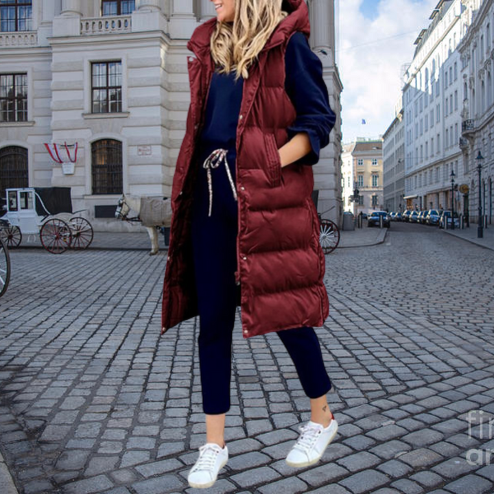 Stylish women's long padded gilet with a hood & cotton blend for warmth and comfort.