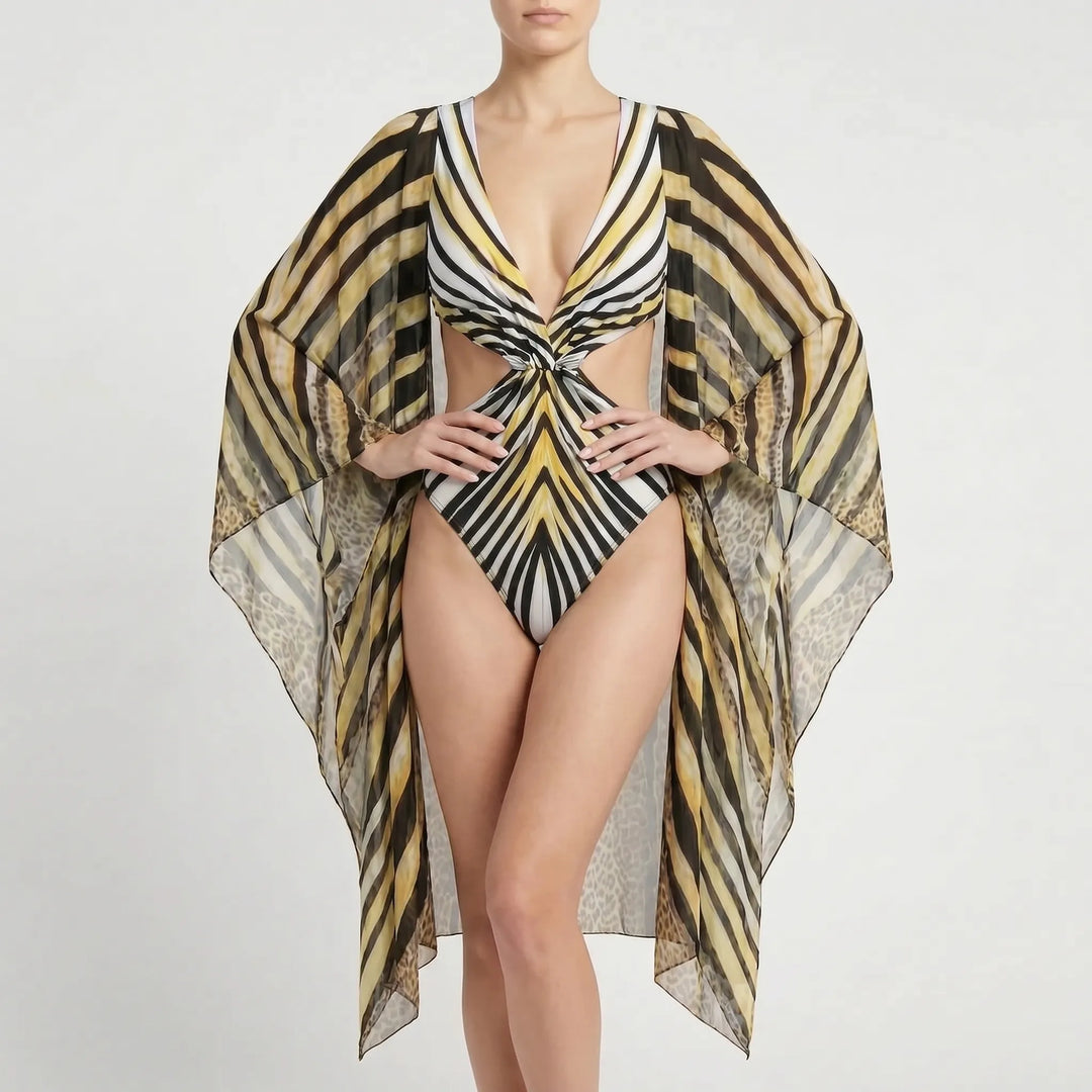 Fashionable women's long-sleeve cutout monokini swimsuit, featuring a bold abstract print for swimwear.