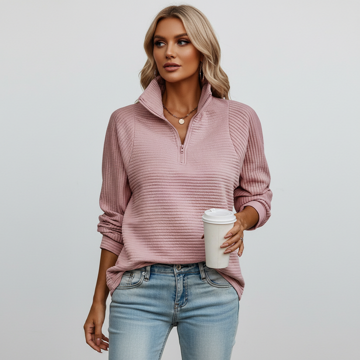 Detail of the ribbed knit fabric on a women's cozy long sleeve pullover, suitable for cold weather