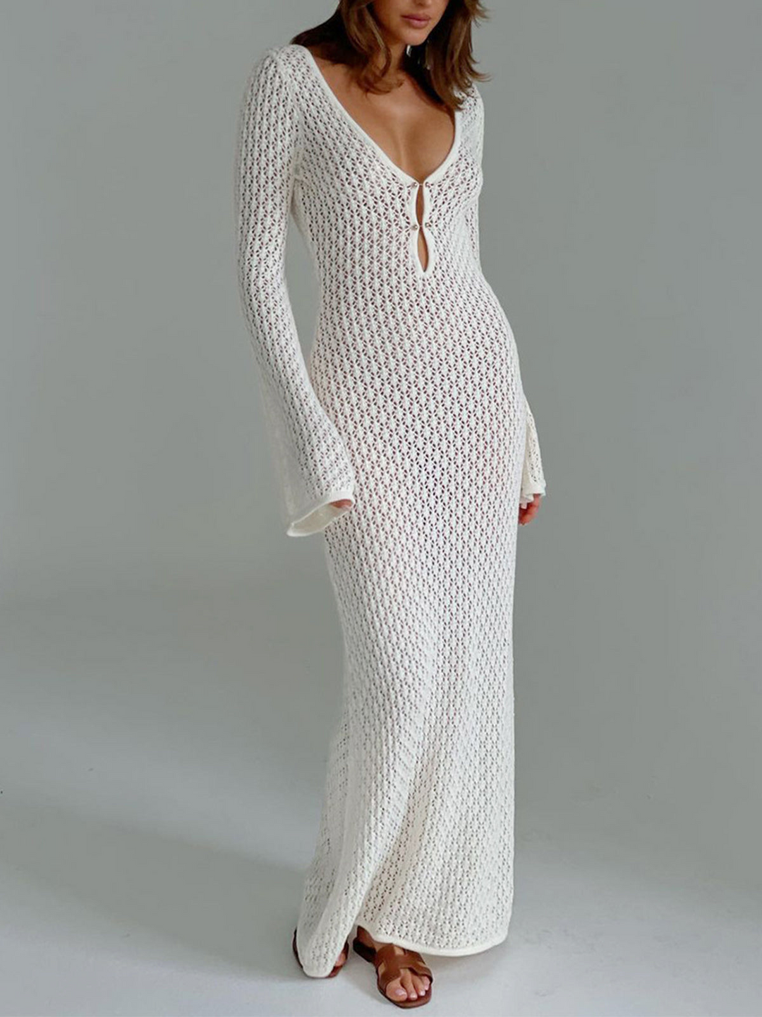 Women's long white beach dress with elegant V-neck and stylish back cutout, perfect for summer vacations.