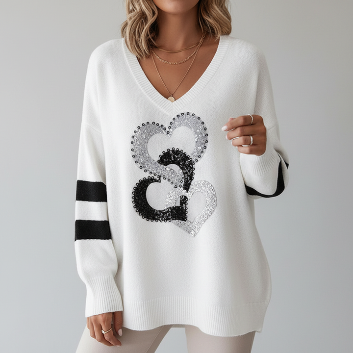 Comfortable women's V-neck sweater, knitted with a charming heart pattern, ideal for winter fashion.