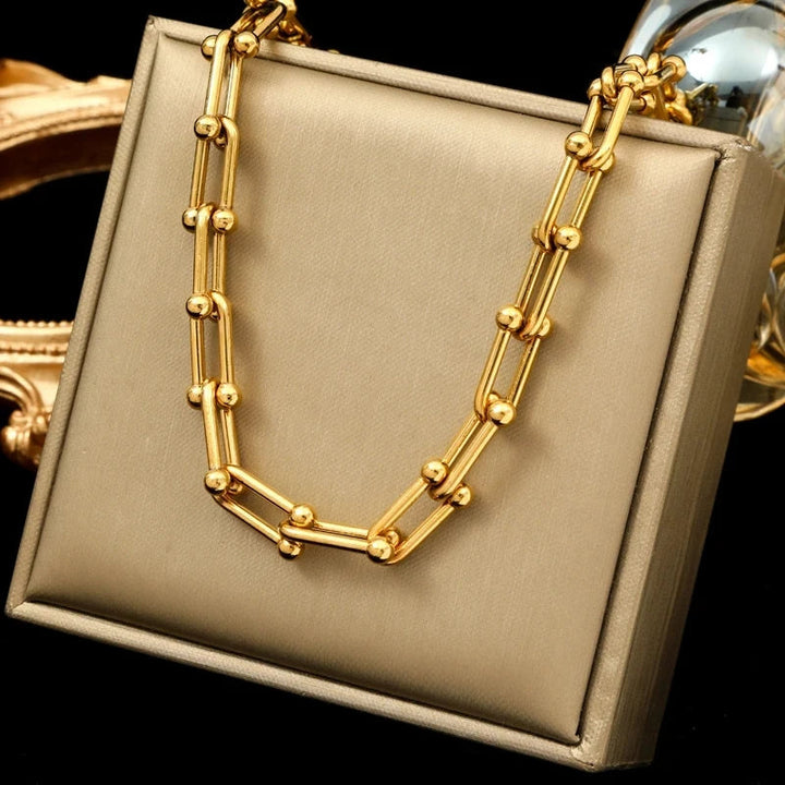 Close-up of Lumiere gold link necklace. Sophisticated women's jewelry, versatile premium plated accessory.