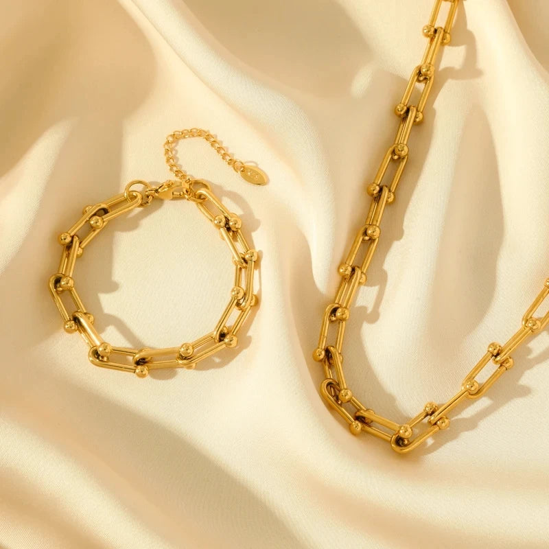 Model wearing sophisticated Lumiere gold link bracelet. Premium plated women's accessory, a chic gift.