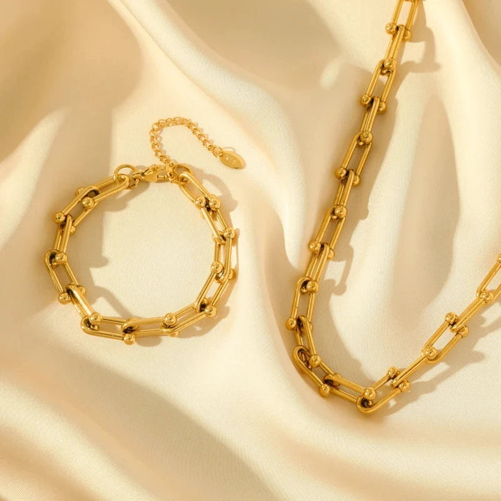 Model wearing sophisticated Lumiere gold link bracelet. Premium plated women's accessory, a chic gift.