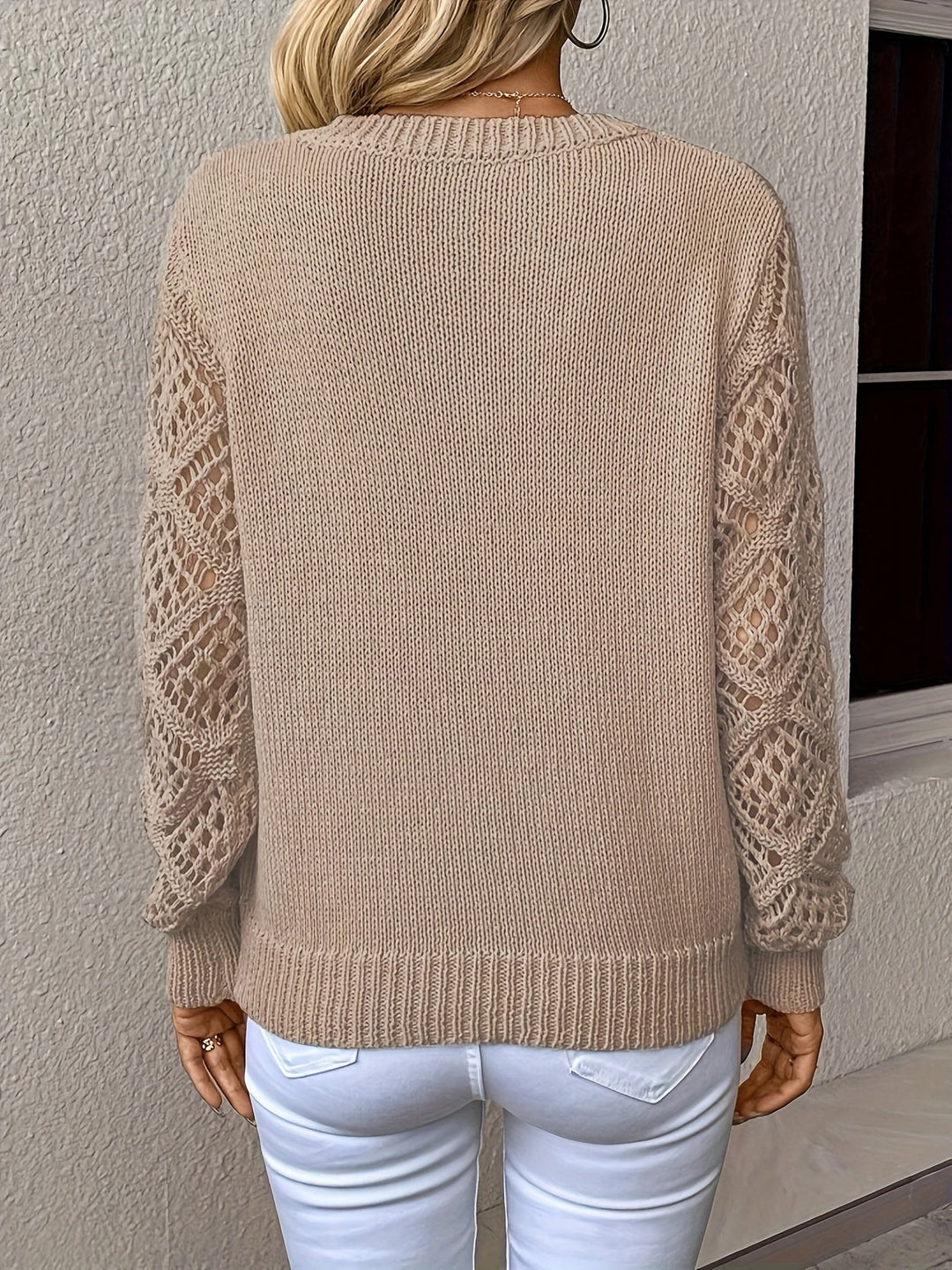 Model wearing a chic Luna women's long sleeve hollow-out knit sweater with V-neck, styled casually.