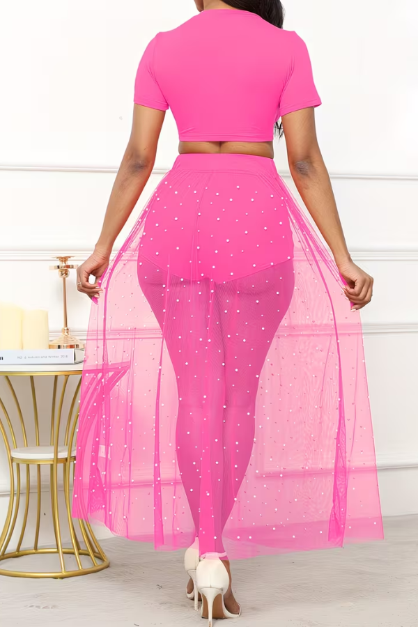 Stylish women's three-piece resort set. Crop top, sheer skirt with pearl details, perfect for beach vacation.