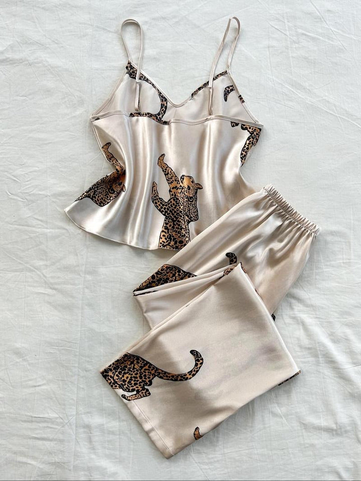 Chic women's satin pajama set featuring a bold leopard animal print. Perfect luxury sleepwear.