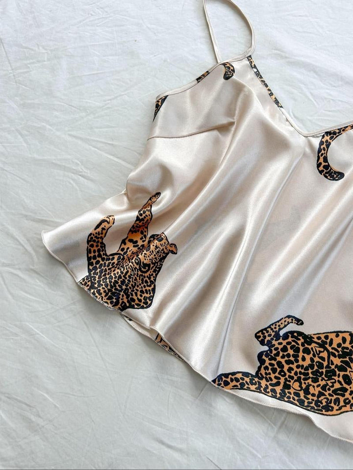 Elegant women's silk pajama set with vibrant leopard print. Luxurious and comfortable sleepwear loungewear.