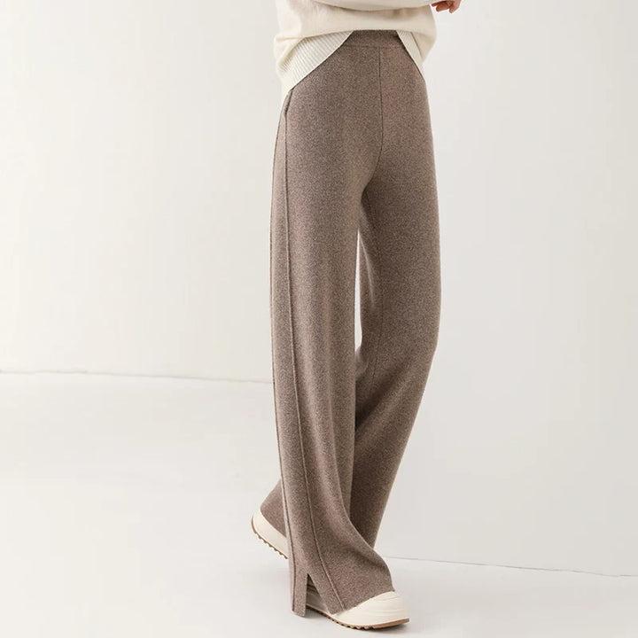 Comfortable women's merino wool pants with stylish side slit, ideal for luxury winter style.