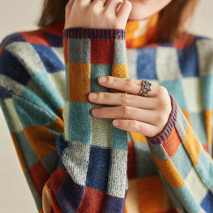 Detail of the intricate patchwork on a women's cashmere roll neck sweater
