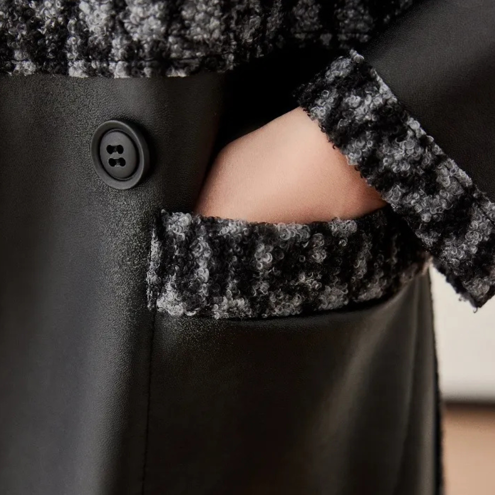 Elegant black luxury women's winter coat, perfect warm outerwear for chic cold weather style.