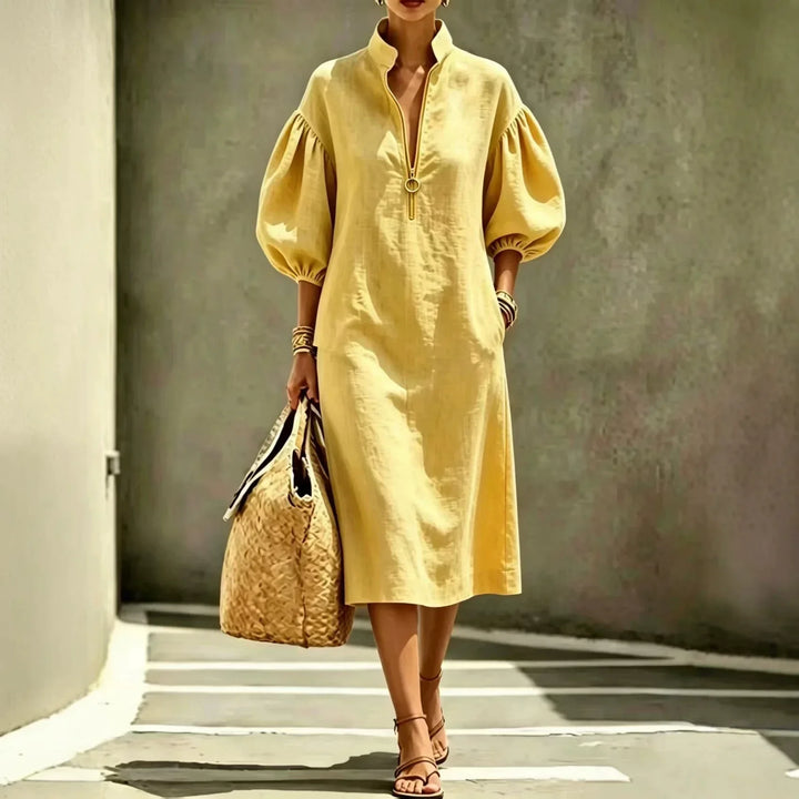 Women's casual chic Madelyn midi dress. Features a trendy half-zip, stylish bubble sleeves, and comfortable relaxed fit.