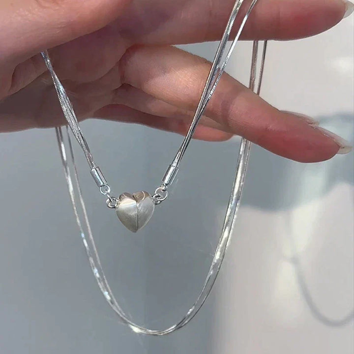 Women's magnetic love heart pendant necklace, sterling silver, adjustable chain. Perfect jewelry gift.