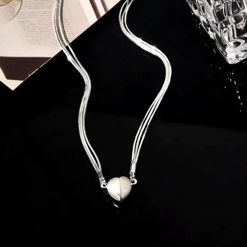 Elegant sterling silver magnetic love heart pendant necklace for women, adjustable and timeless jewelry gift.