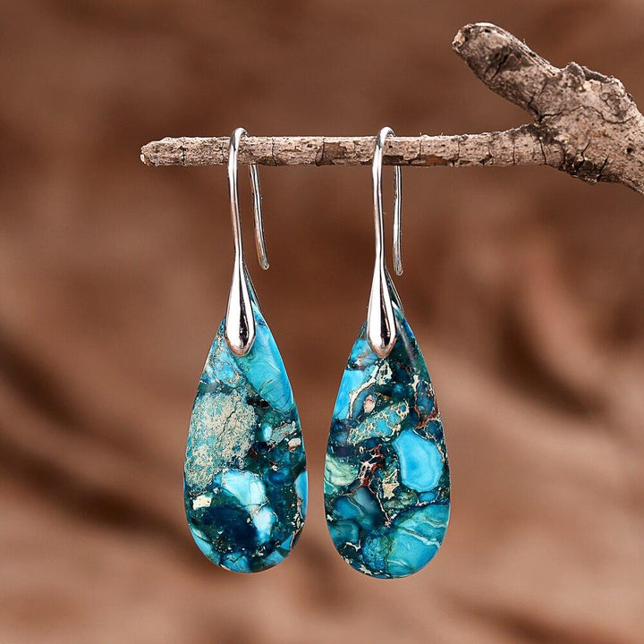 Women's Marisol Ocean Energy drop earrings with calming regaliet stone. Handmade protective silver/gold gemstone jewelry.