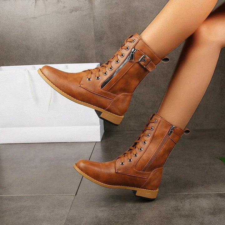 Side view of Women's Mason mid-calf boots, highlighting multiple buckle straps & sturdy sole.
