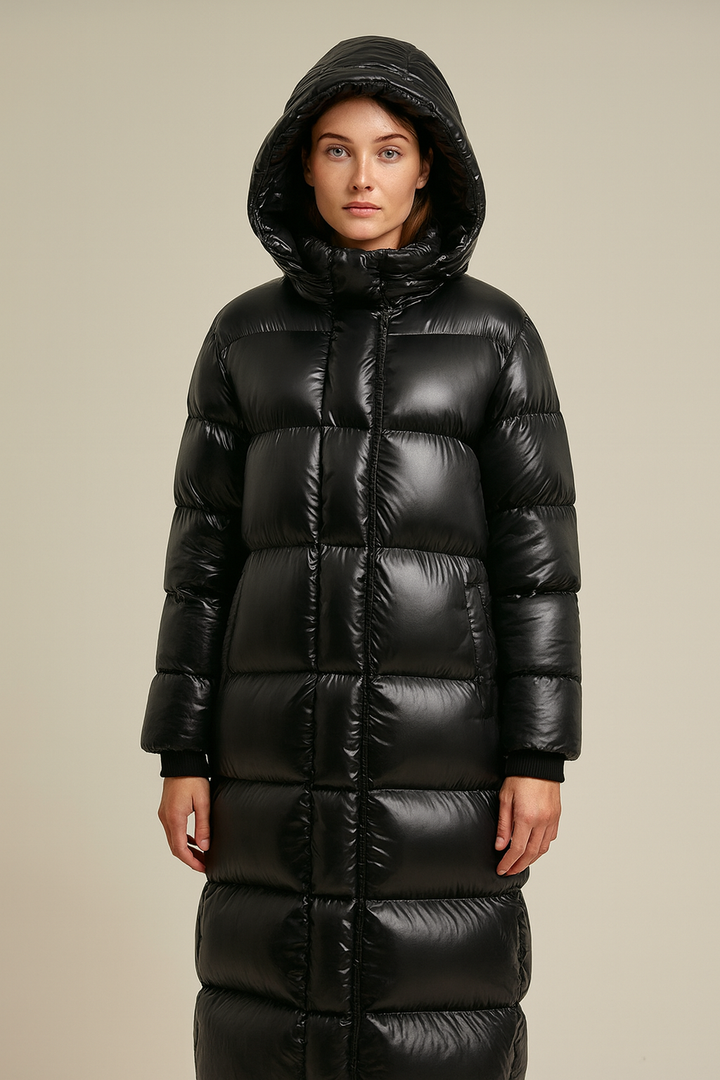 Women's maxi quilted hooded winter jacket for cold weather protection and warmth.