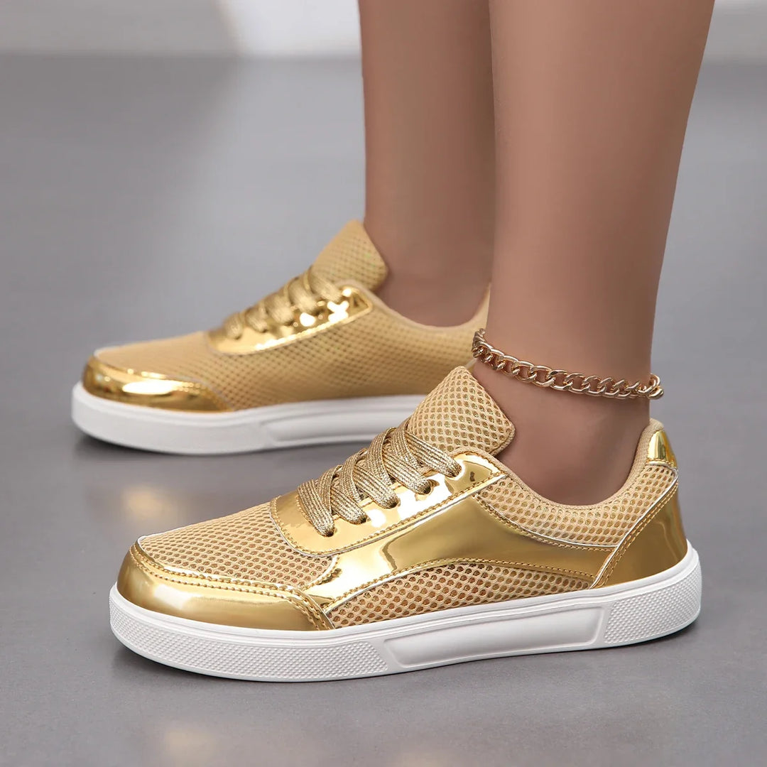Close-up of women's metallic mesh sneakers. Detailed, breathable lace-up design offering chic style & comfort.