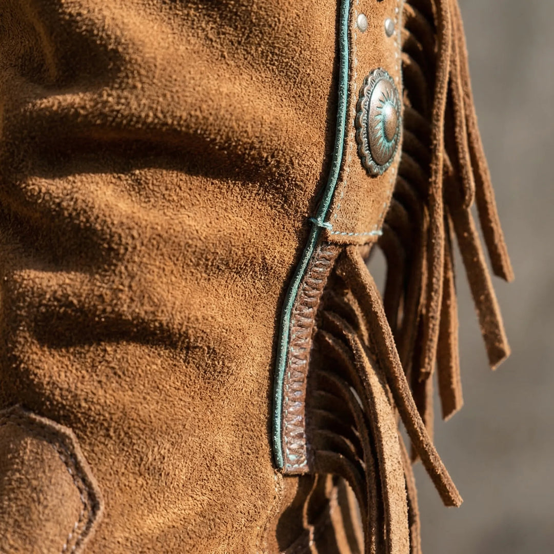 Slouchy mid-calf western boots with playful fringe, perfect for a bohemian fashion look.