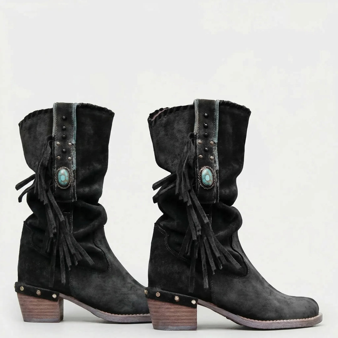 Slip-on mid-calf western boots with fringe & a pointed toe, ideal for women's boho fashion.