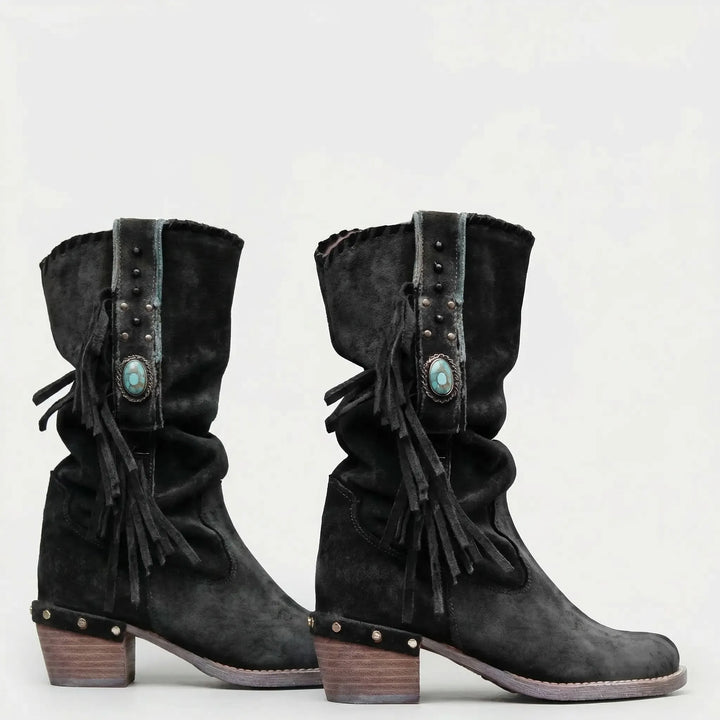 Slip-on mid-calf western boots with fringe & a pointed toe, ideal for women's boho fashion.