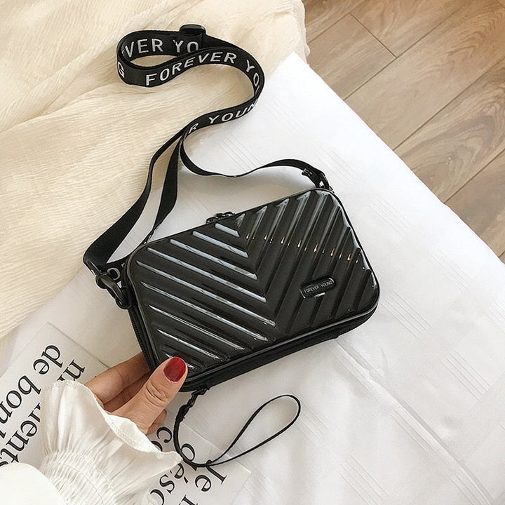 Compact hard shell pvc crossbody bag in black, ideal women's travel accessory